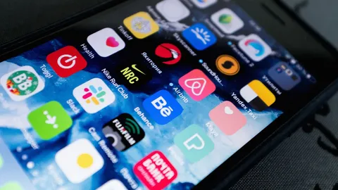 Mobil uygulama ekranlarını gösteren bir telefon